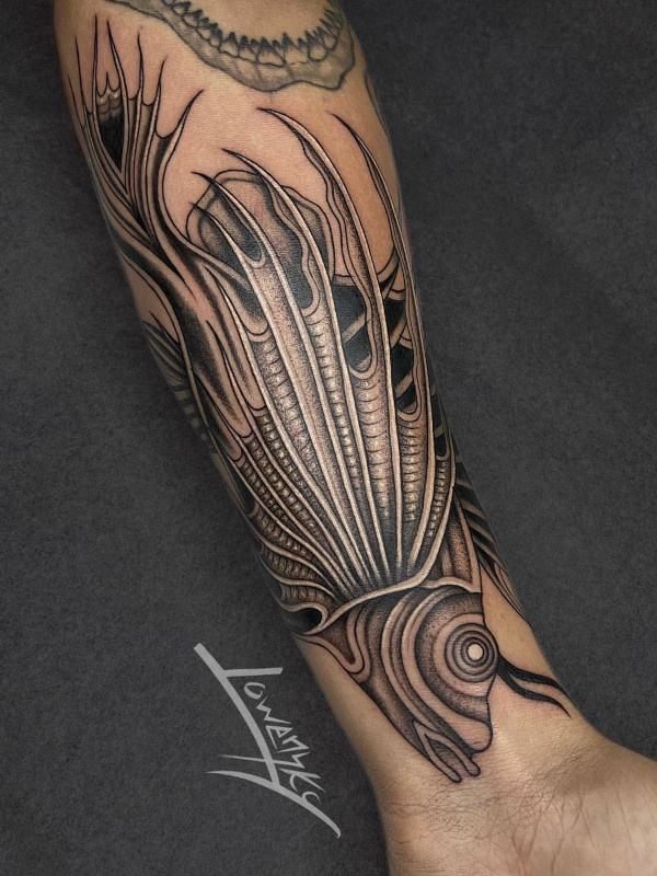 Black and grey fine line stylized fish forearm tattoo by tattoo artist Lowensky Santiago of Sacred Mandala Studio in Durham, NC.